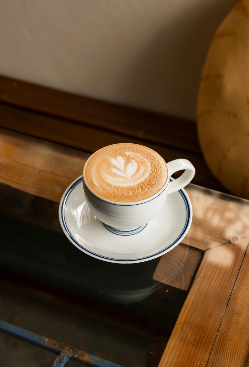 A selection of different coffee beans spread out on a table, showcasing a variety of colors and textures.